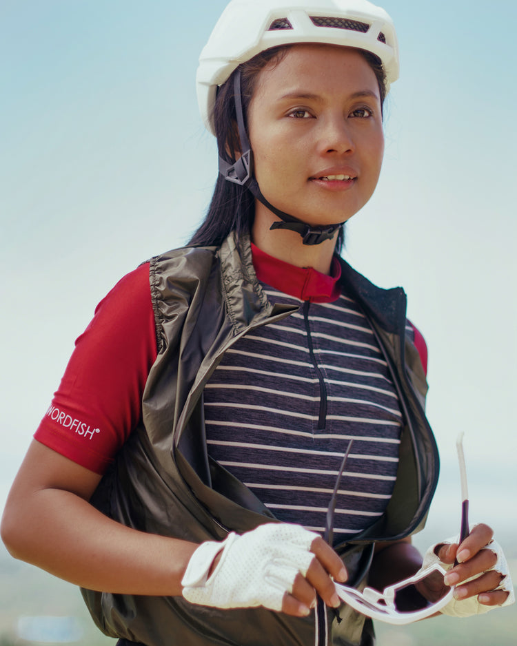 women with helmet wearing red sleeves with stripes jersey
