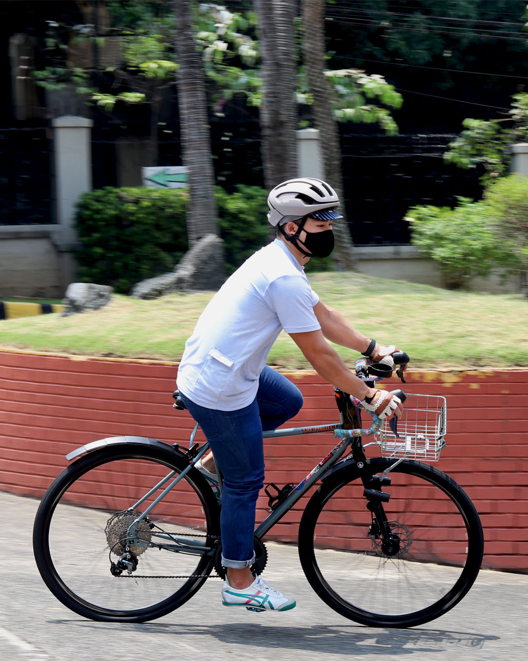 man biking with helmet, cycling cap, olympic knit gloves and bike